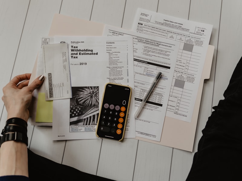 Desk with calculator and financial documents — starting a tax business